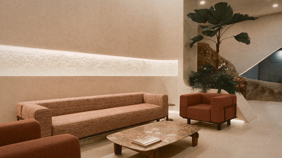 Uma sala com parede de pedra, sofás e uma planta